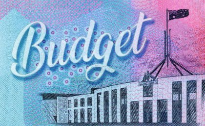 Treasurer Jim Chalmers hands down second budget and UQ has the expert analysis. Adobe Federal Parliament building on ten dollar note background with the word budget written in cursive.